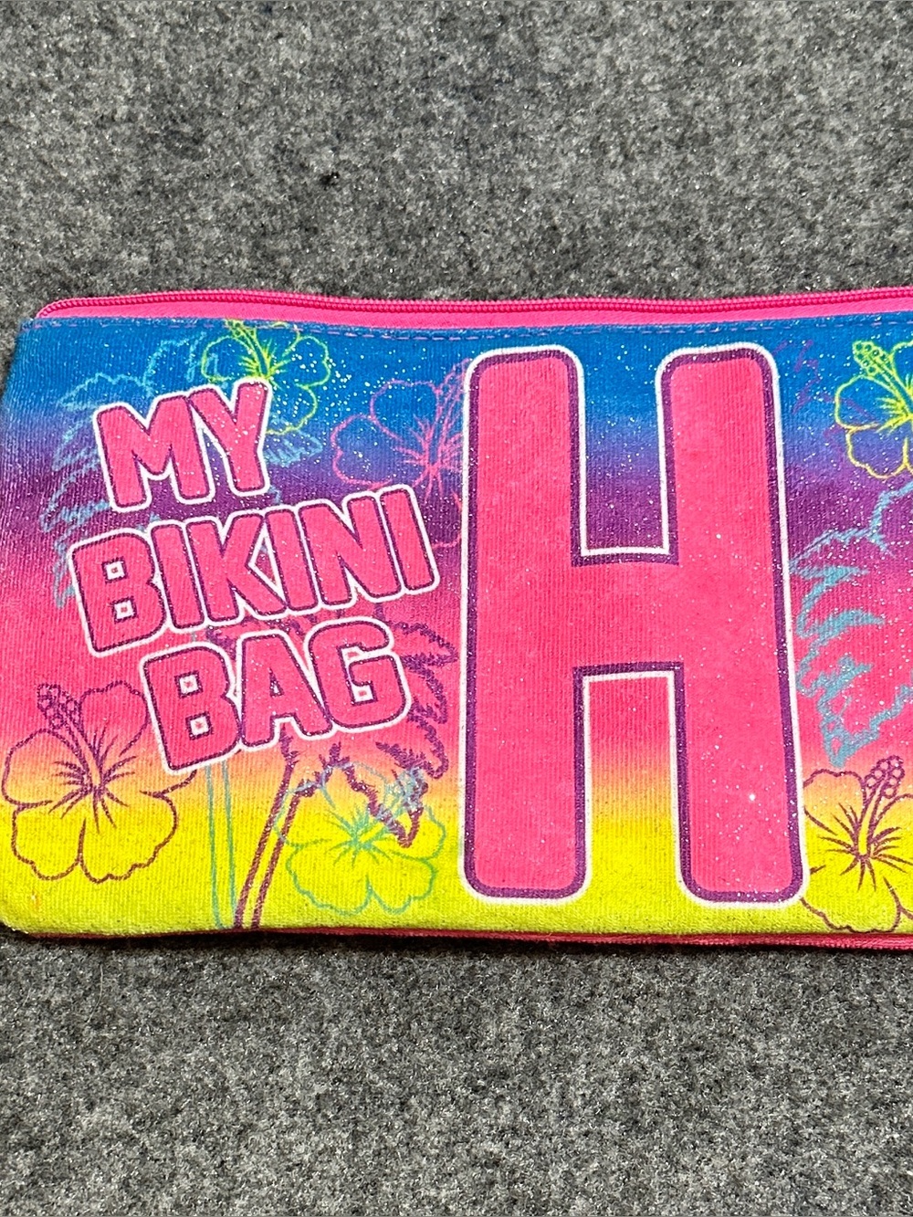 This is a Justice "My Bikini Bag" featuring a large glittery letter H